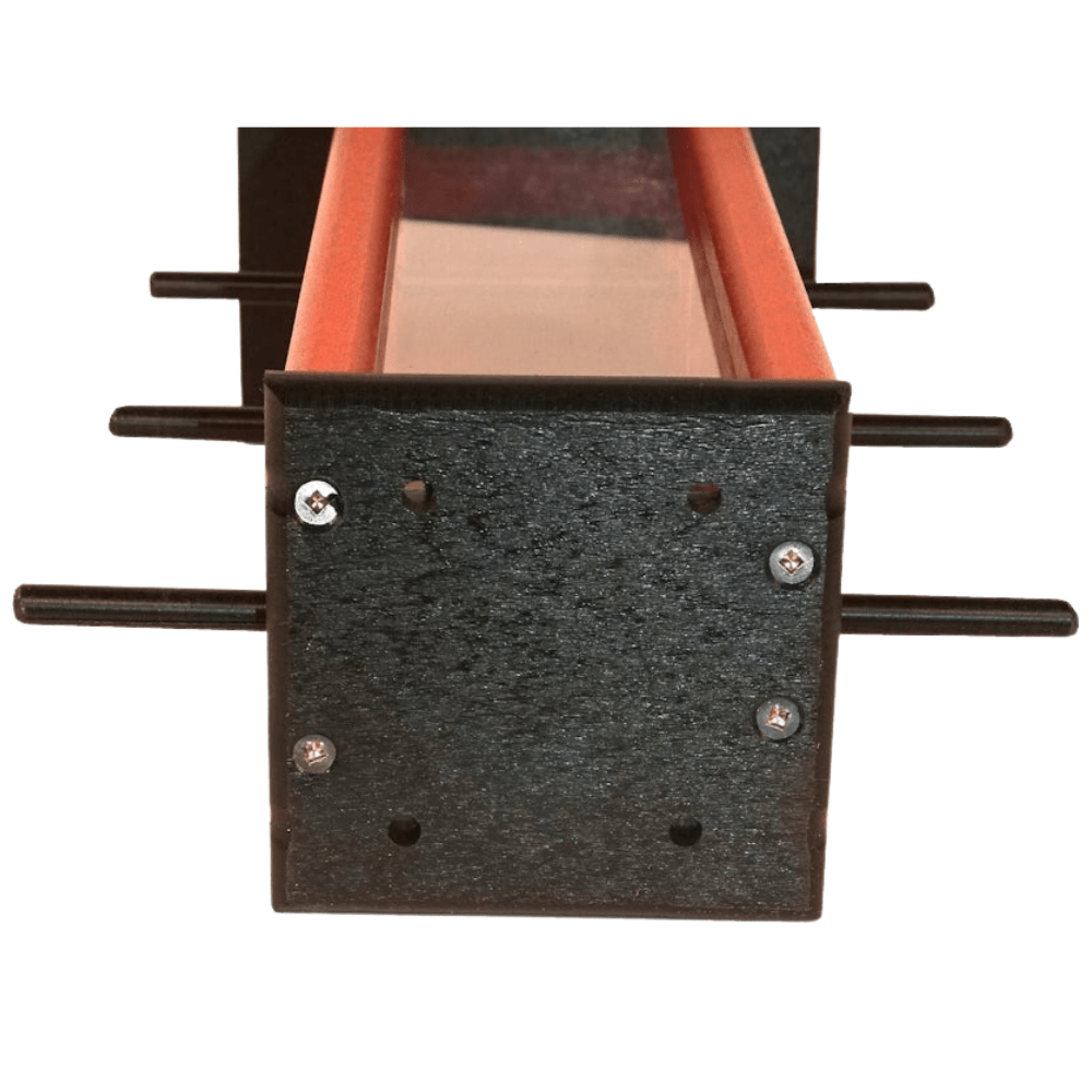 Close-up of holes on bottom of finch feeder on a white background