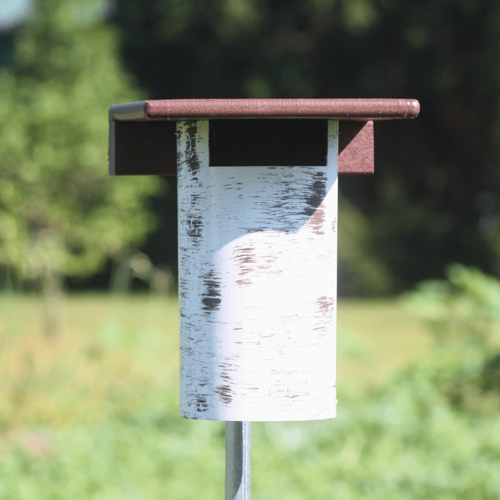 Gilbertson Bird house with a natural design on a blurred green background